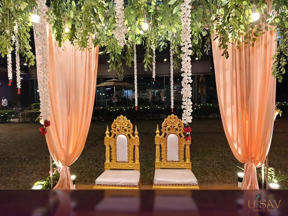 Garden ceremony frame with peach drapery and gold seating