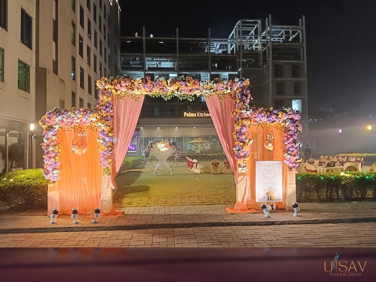 Outdoor garden welcome arch with peach floral decor